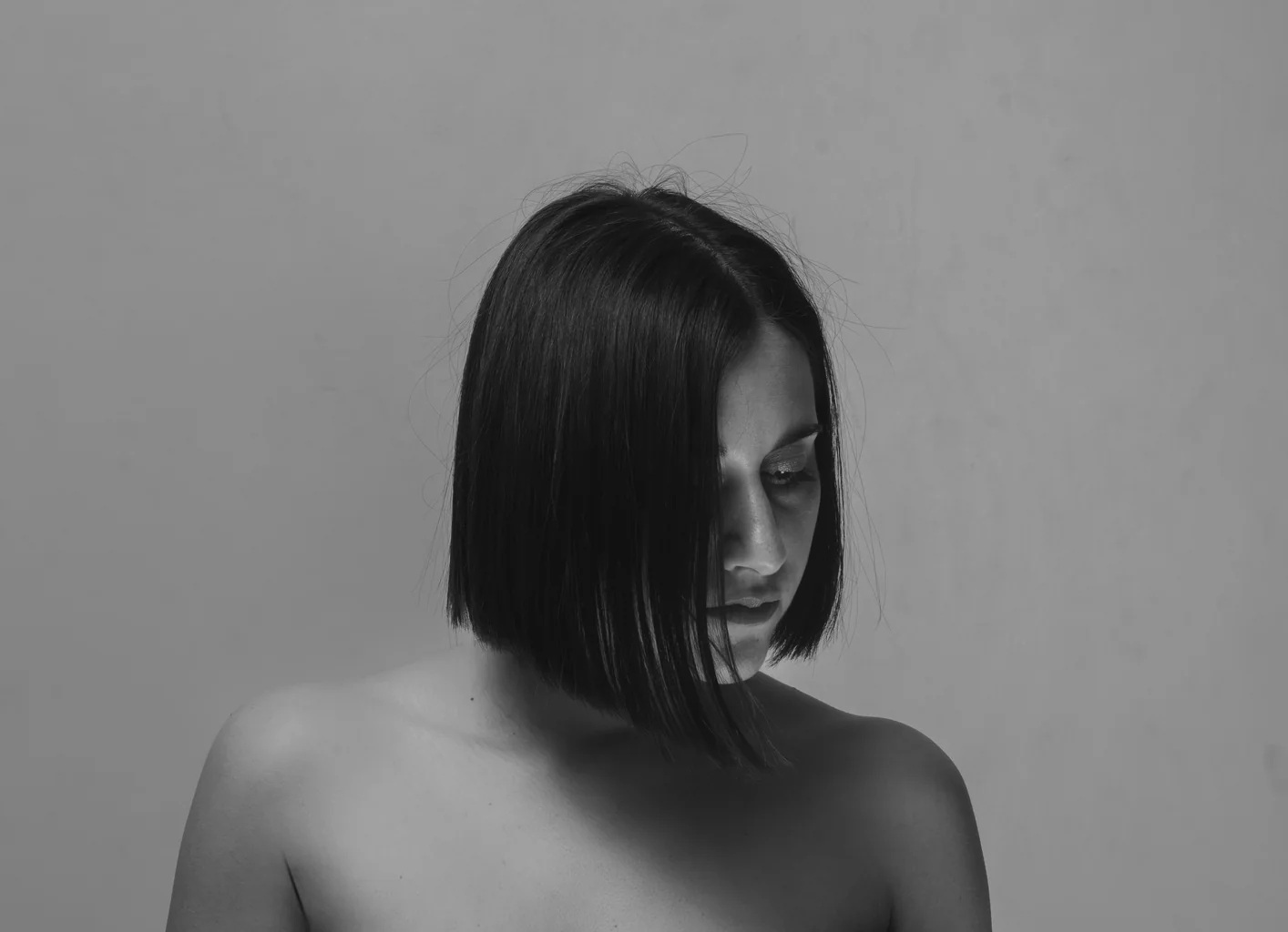Chiara, head bowed, the bob haircut hiding half her face