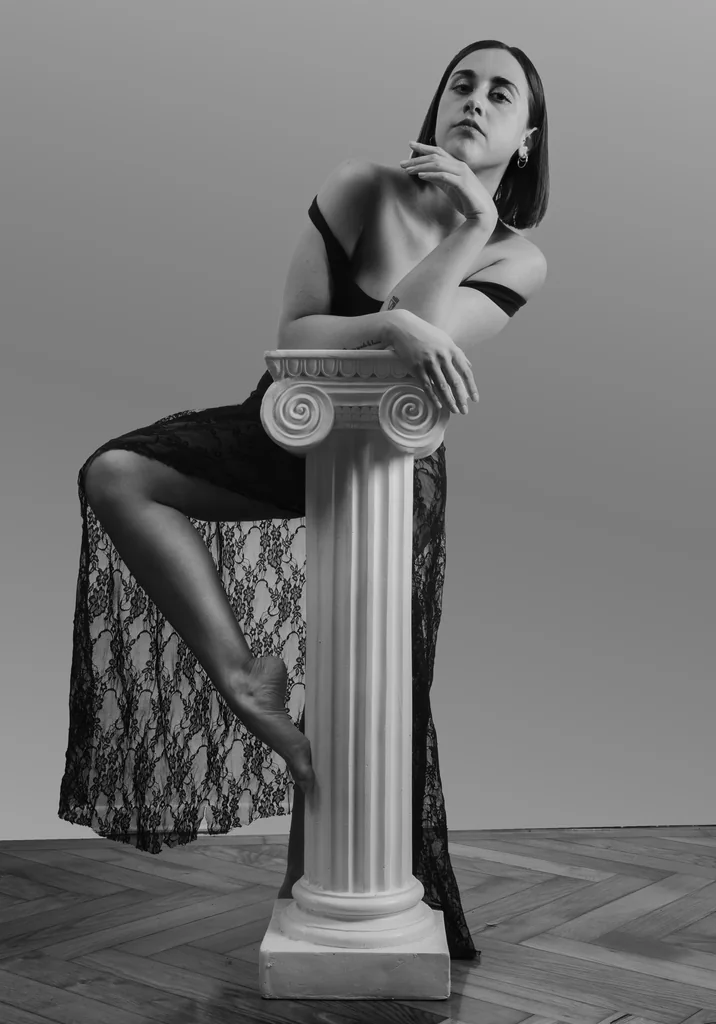 Leaning on a classical column in black lace