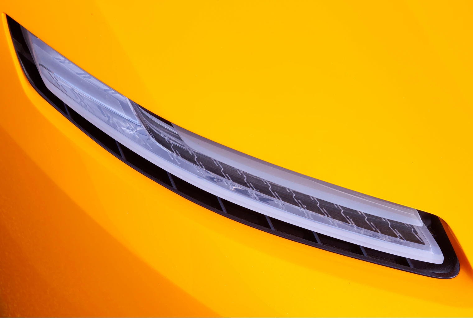 Slim LED headlight cut into the yellow bodywork