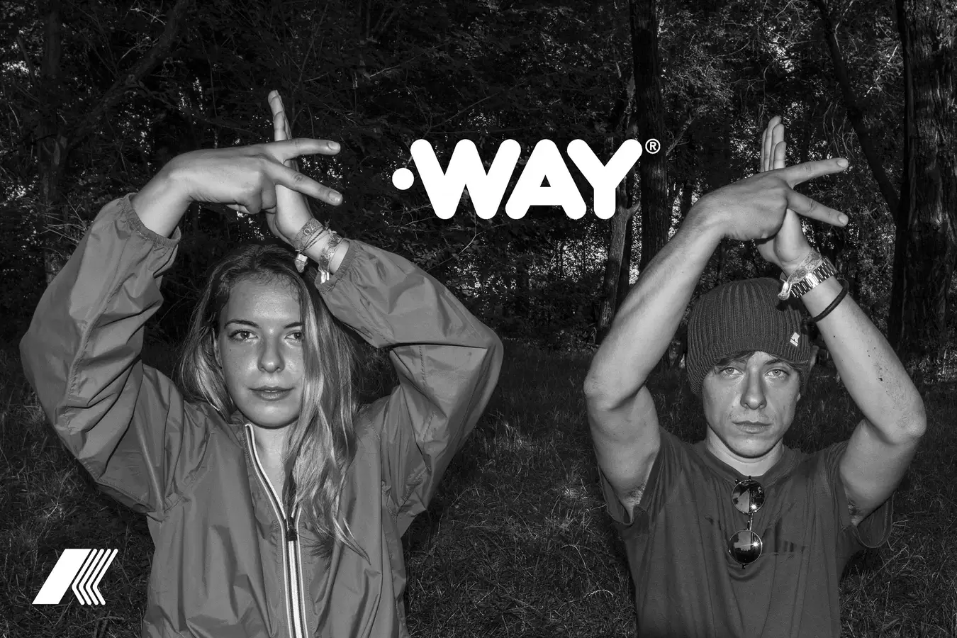 Two models in the woods forming the K with their arms beneath the WAY logotype